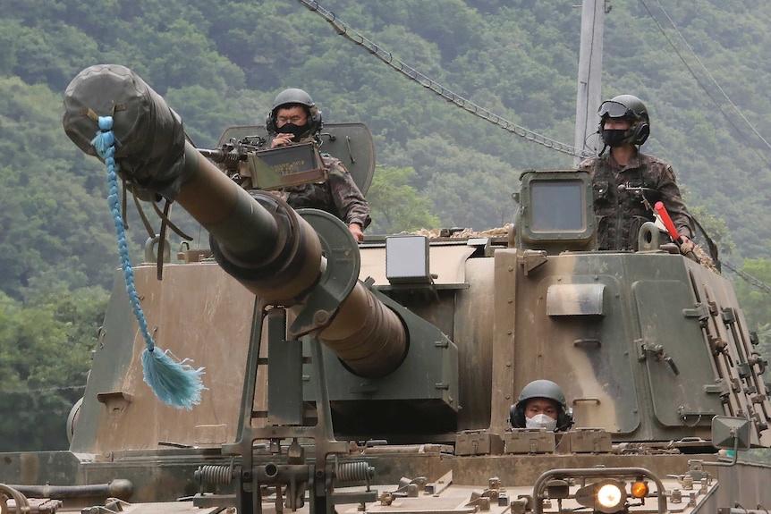 South Korean army soldiers ride a howitzer tank during a training exercise near the border with North Korea.