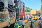Firefighters gather around a train.