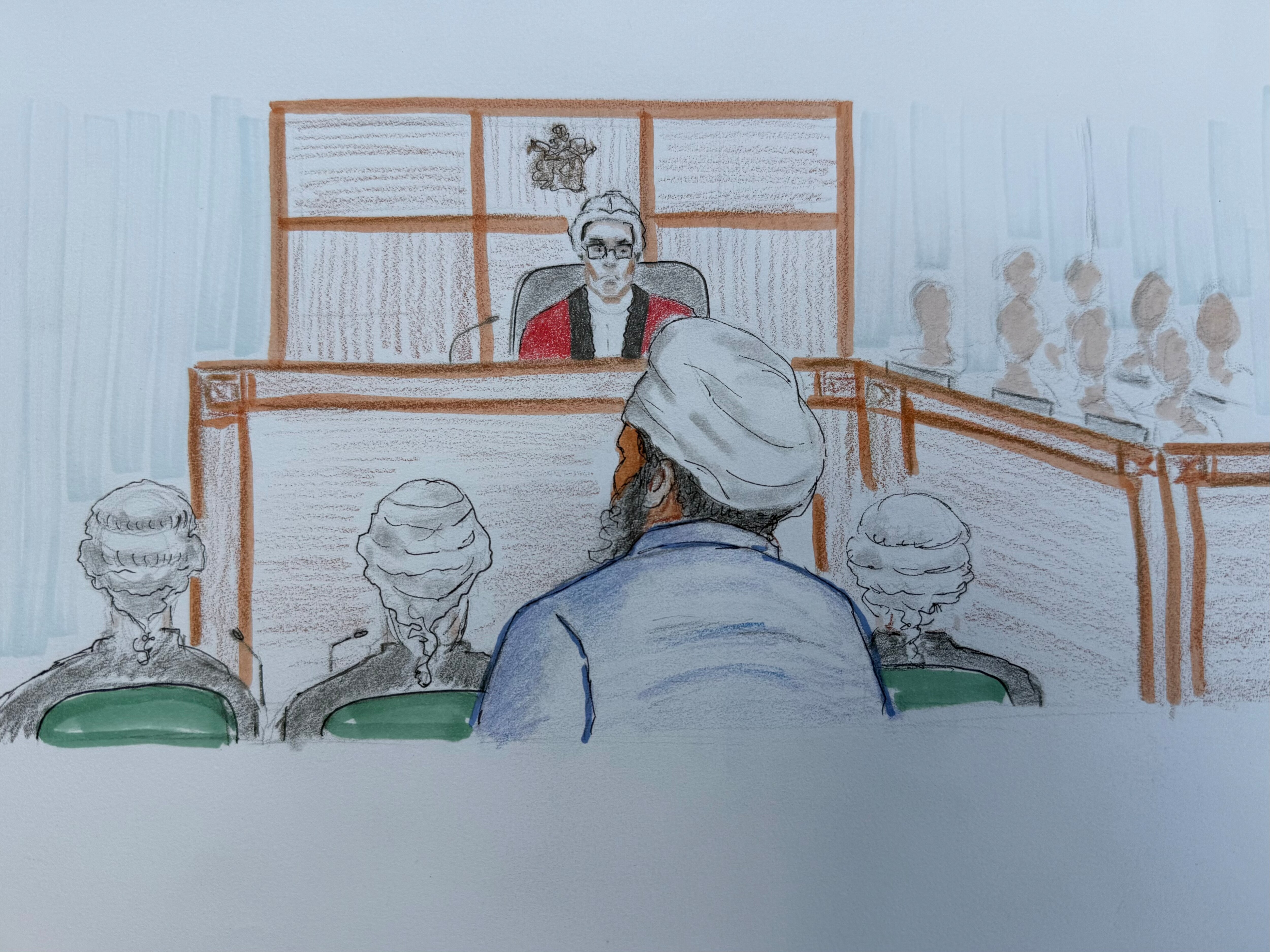 court sketch of a man in a turban facing a judge