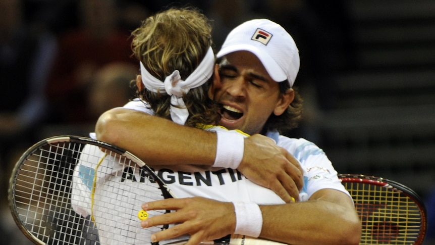 Still alive ... David Nalbandian (L) and team-mate Eduardo Schwank celebrate after Argentina's doubles win.