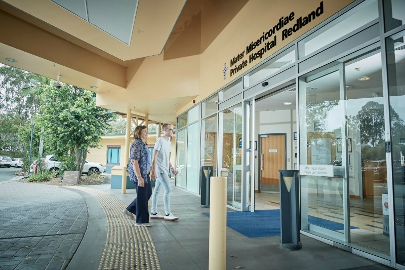 People walking through the doors of the Mater Private Hospital Redland entrance.