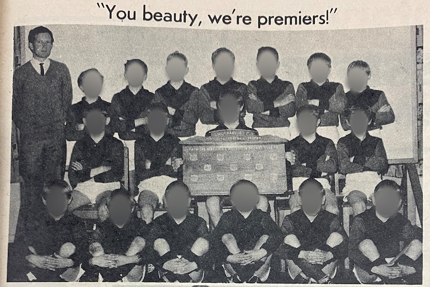 A group of boys in football gear pose for a photo with their coach.