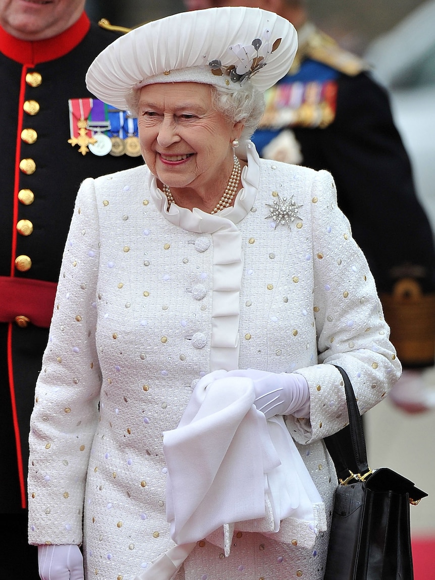 Queen Elizabeth II arrives at Chelsea harbour to embark to join the Thames Diamond Jubilee Pageant.