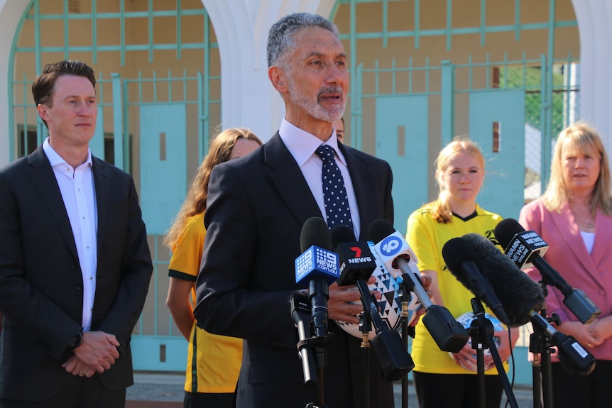 WA Sports Minister Tony Buti speaking at a media conference with four other people standing behind him.