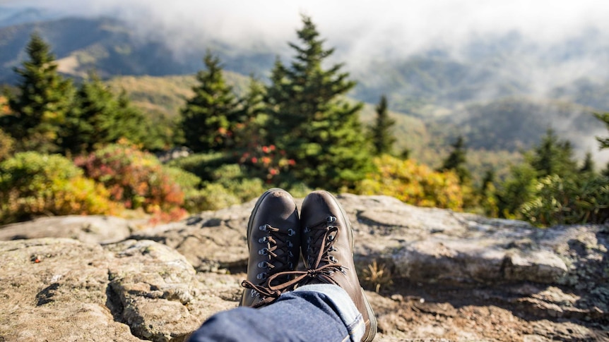 A man puts his feet up after a hike.