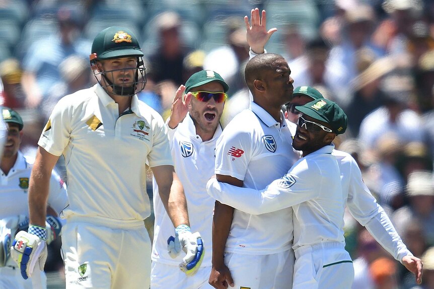 Shuan Marsh trudges off as Vernon Philander celebrates