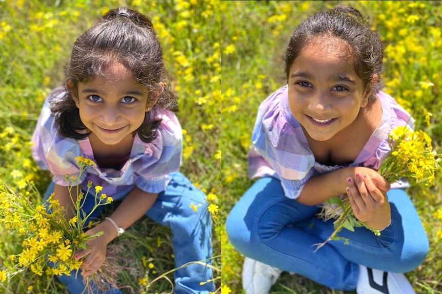 Kopika and Tharnicaa smiling, sitting in a field of green and yellow flowers.