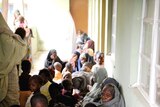 Nigerian women and children take refuge in a police office