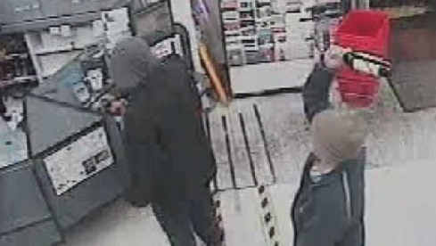 CCTV vision shows a customer hitting a man over the head during a robbery.