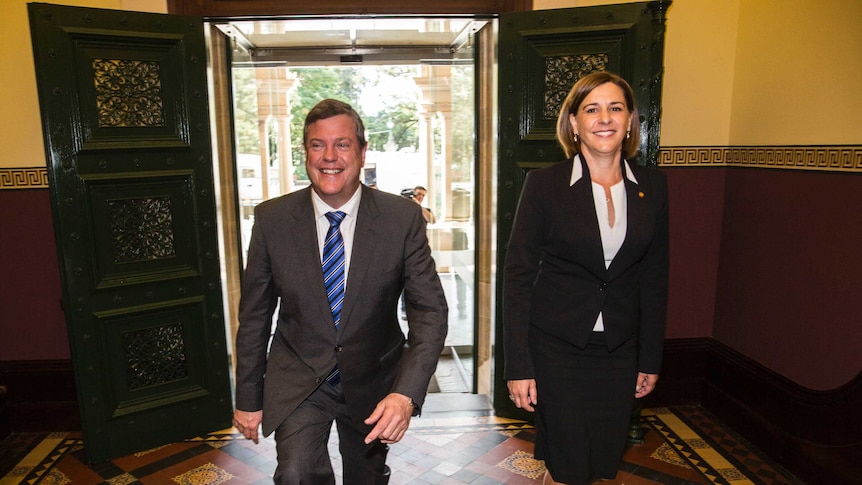 Tim Nicholls and his deputy Deb Frecklington walk down a corridor.