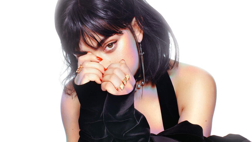 Charli XCX posing on the front of her POP2 mixtape