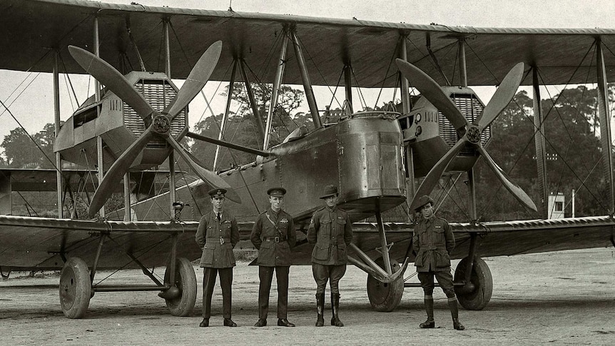 Keith Smith, Ross Smith, James Bennett and Wally Shiers standing by the Vickers Vimy G-EAOU.