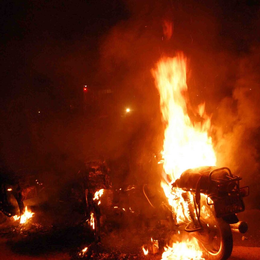 A motorcycle burns after a fuel tanker caught on fire in Kampala suburb.
