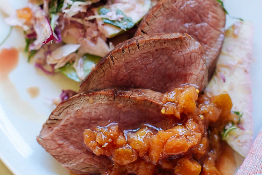 A close up of meat with chutney