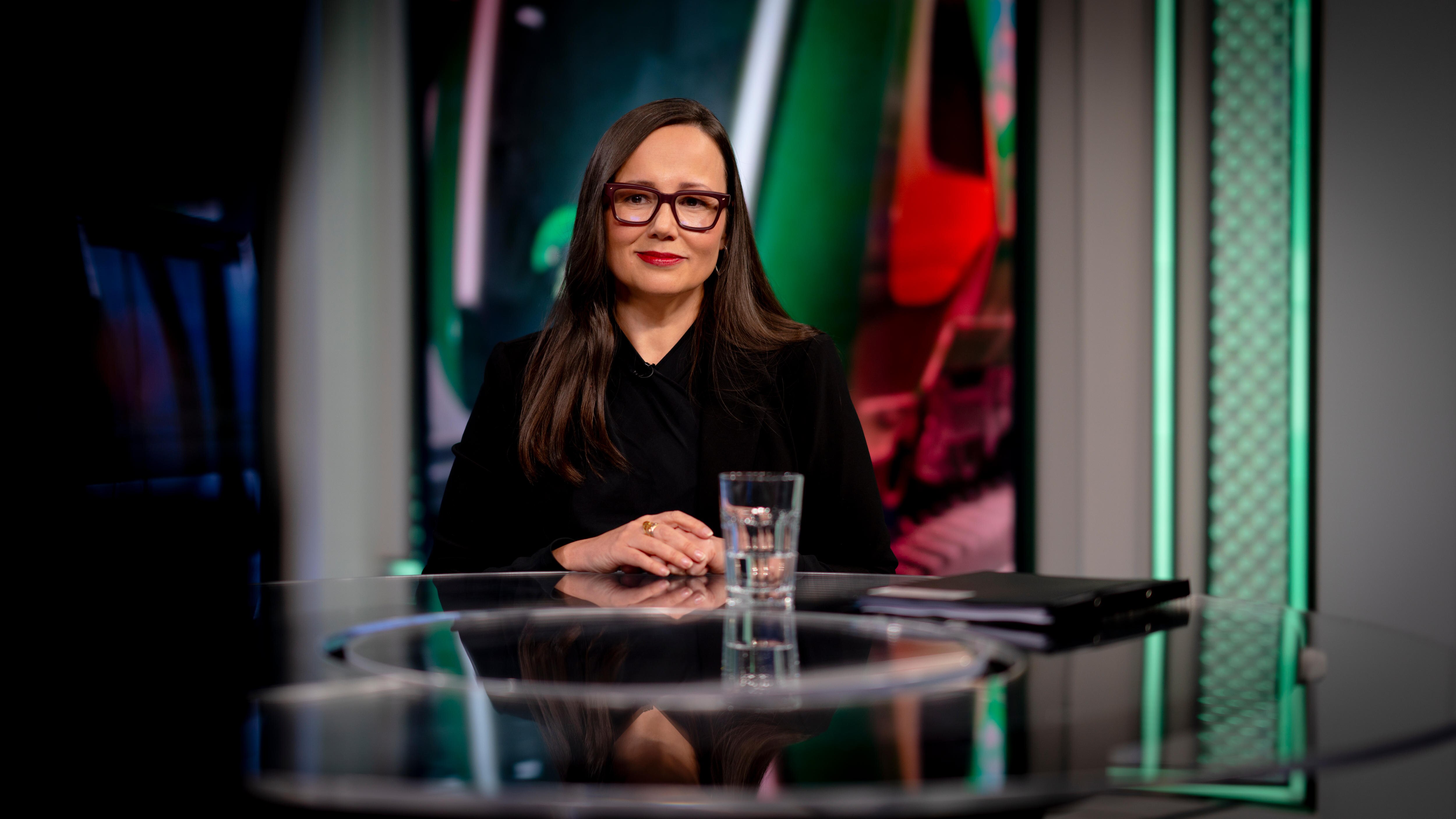 A female Victorian politician dressed in black, wearing glasses, seated in an ABC TV studio