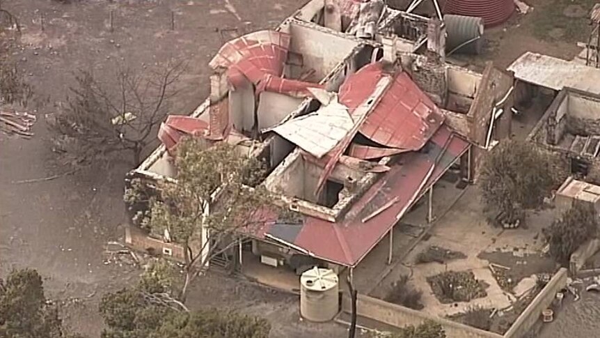 A majorly damaged home with its roof collapsed