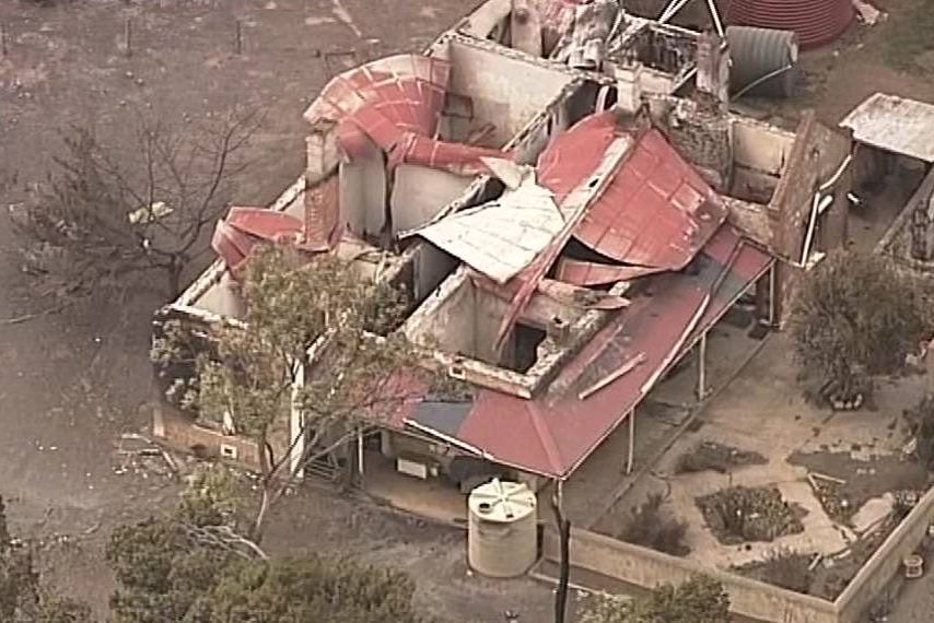 A majorly damaged home with its roof collapsed