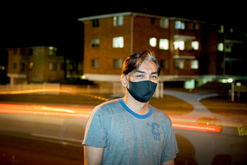 A man with a face mask on the street.