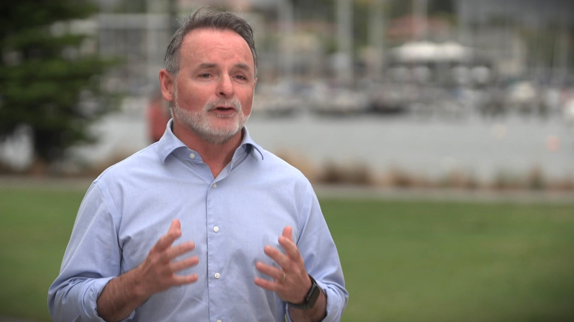 David O'Byrne gestures with both hands at a press conference outside.