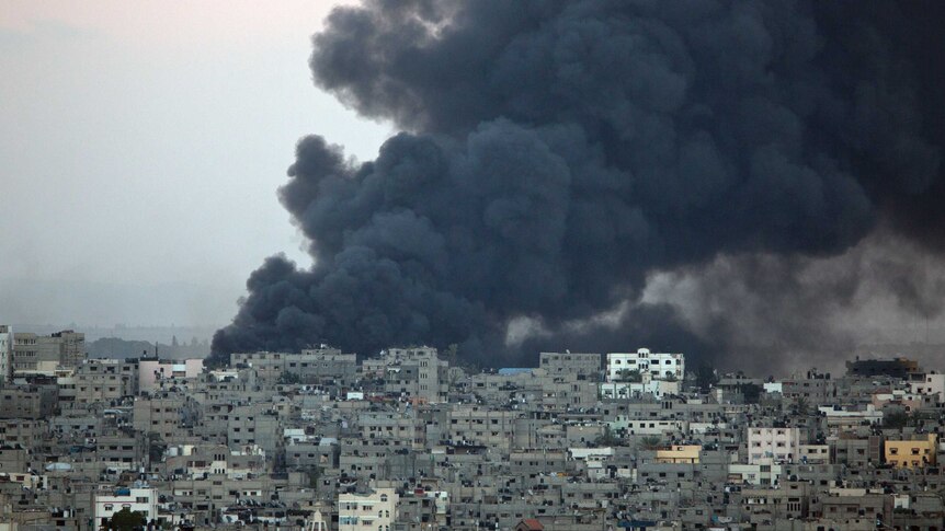 Smoke billows from a Gaza building hit by an Israeli air strike