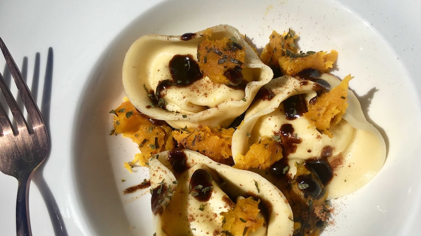 Hand Made three cheese Tortelloni with a vino cotto cocoa sauce, roasted pumpkin, fresh tarragon and dark chocolate.
