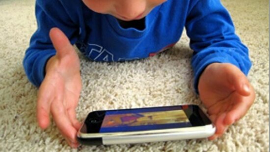 A child plays with a smartphone.