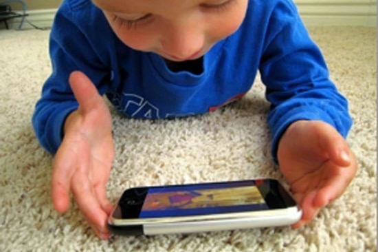 A child plays with a smartphone.