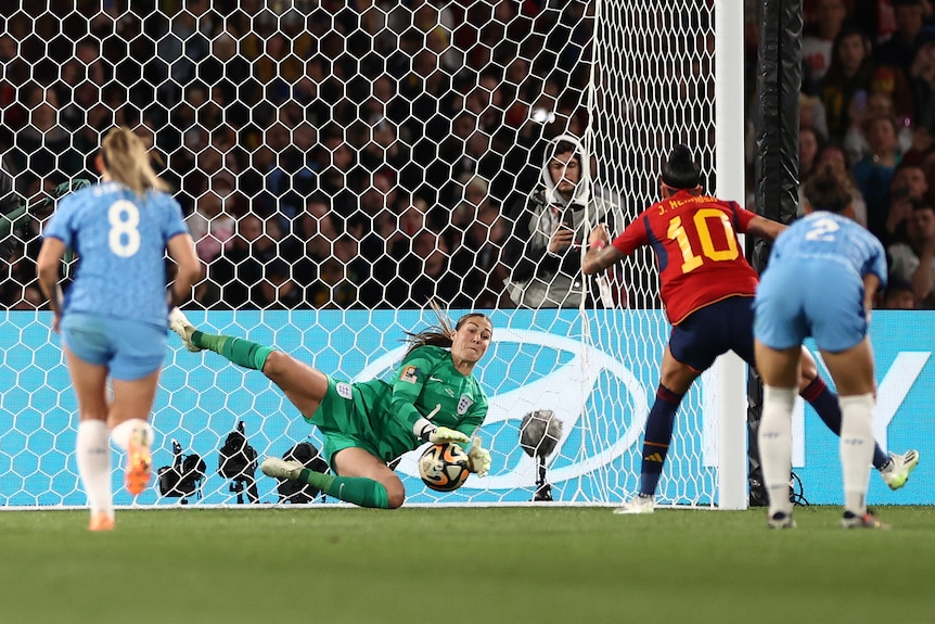England goalkeeper Mary Earps dives to save a penalty in the Women's World Cup final against Spain.