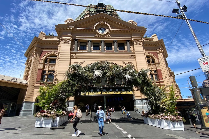 A huge wreath of flowers around the entrance to Flinders Street train station.