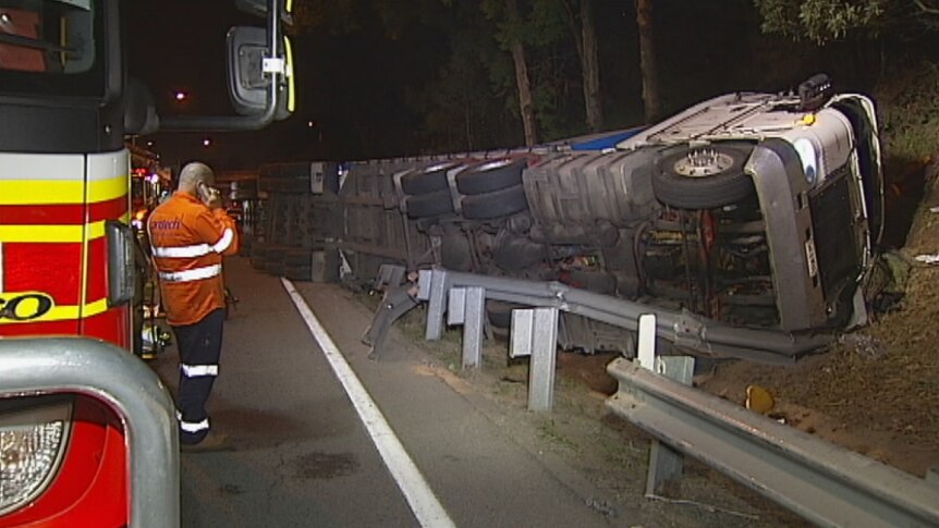A 36-year-old man died after the B-double truck he was driving overturned on the Pacific Motorway