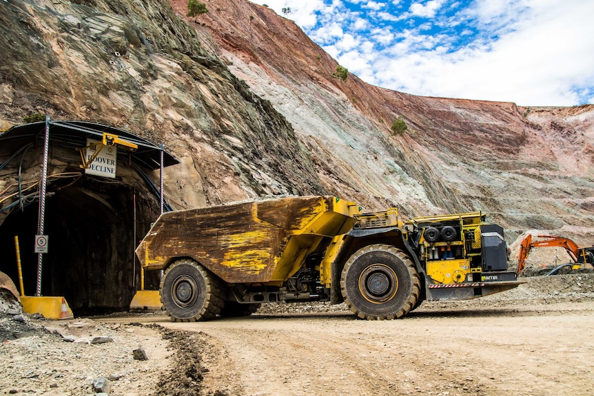 A mining truck returning to the surface from underground portal.