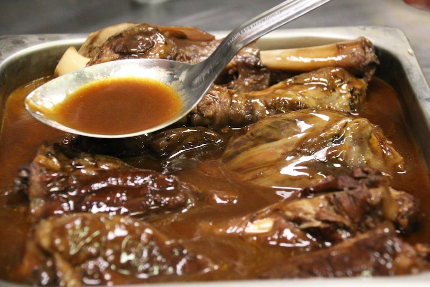 Roast meat and gravy in a tray