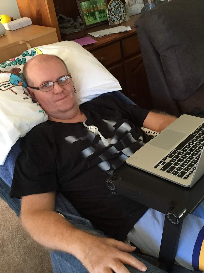 Matthew Hodge using laptop computer