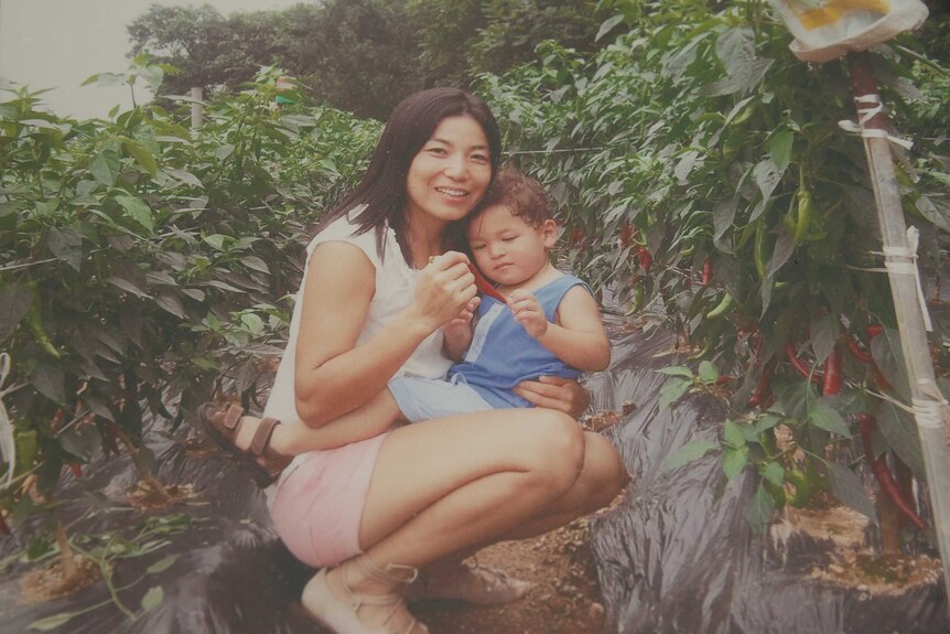 A woman and her son in a garden