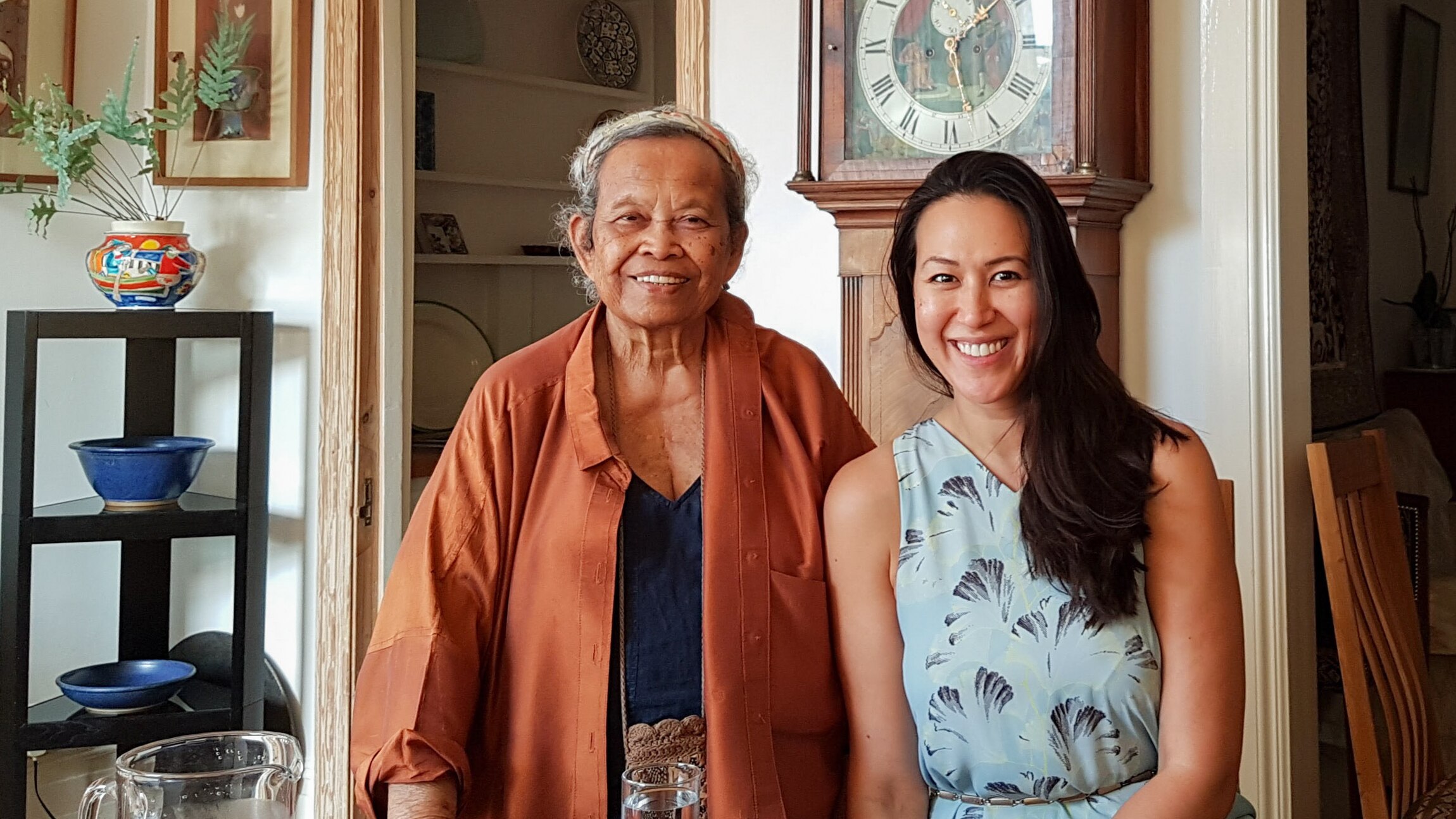 Lara Lee sands with Sri Owen smiling at the camera