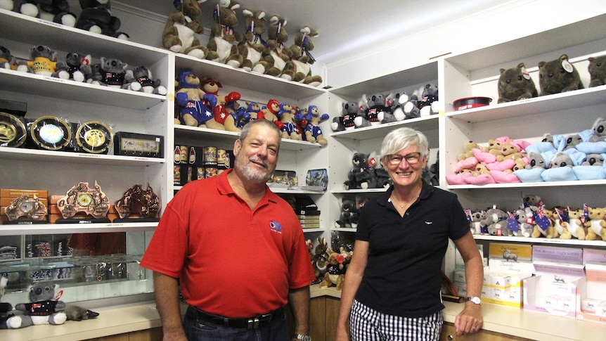Two people stand in a shop filled with Australiana souvenirs