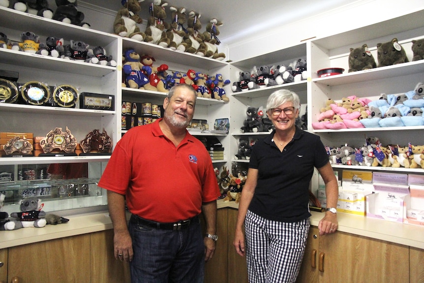 Two people stand in a shop filled with Australiana souvenirs