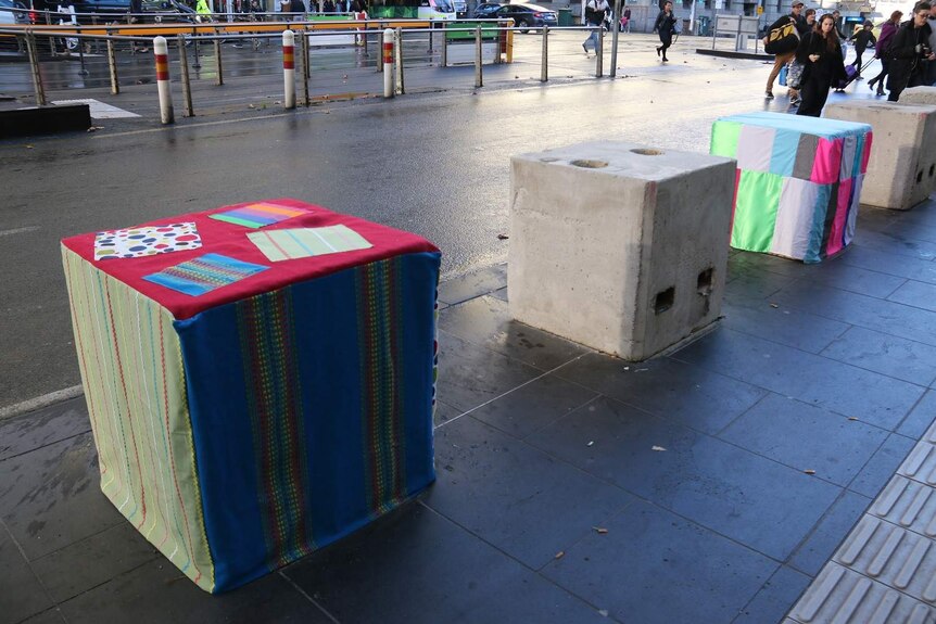 Bollards covered in colourful material at Southern Cross Station.