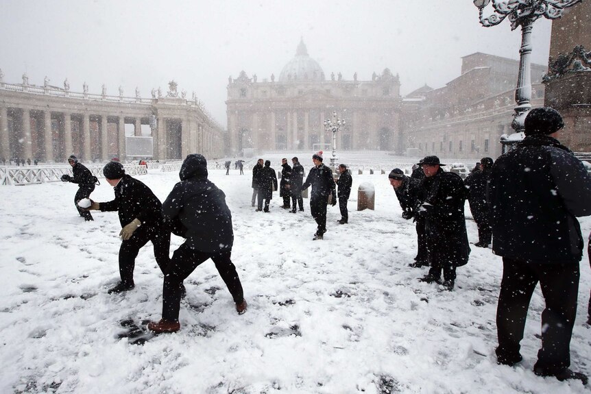 Seminarians of the Pontifical North American College in Rome play in a snow blanketed St Peter's Square.