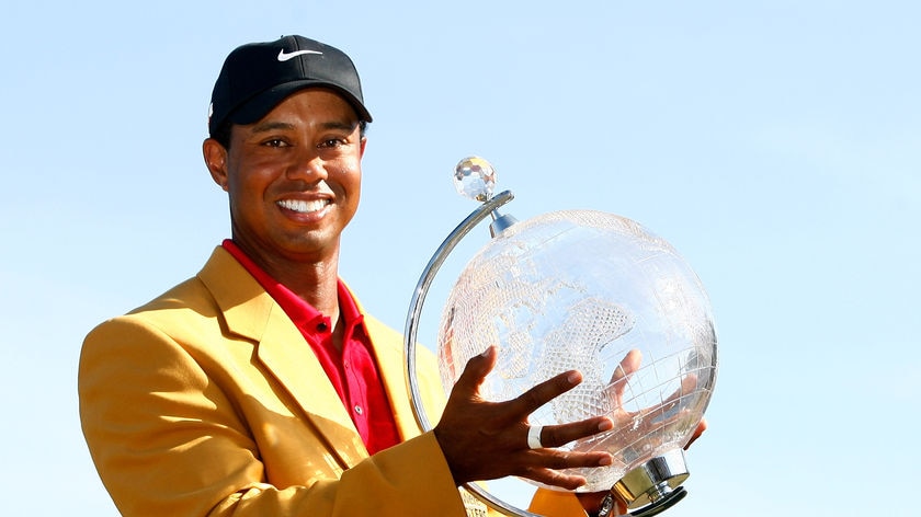 Happier days ... Tiger Woods poses with the 2009 Australian Masters trophy