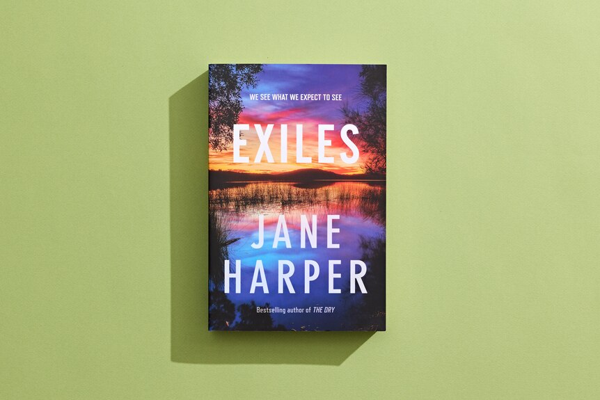 Book cover featuring the words Exiles and Jane Harper with purple and orange and red background