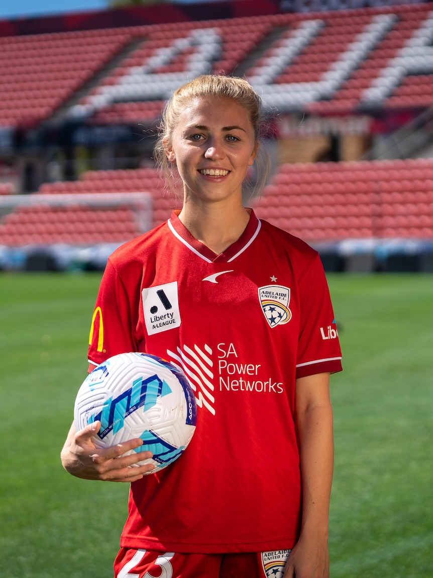 Adelaide United striker Fiona Worts standing on a soccer pitch