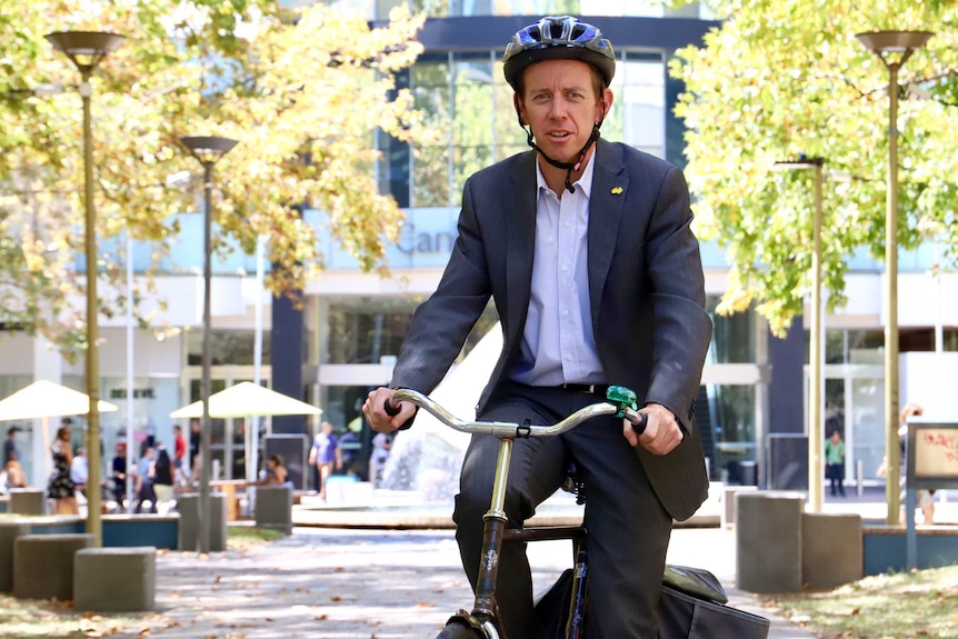 Shane Rattenbury on his bicycle in Civic.