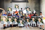 Supporters of SA Liberal candidate Jing Lee hold posters.