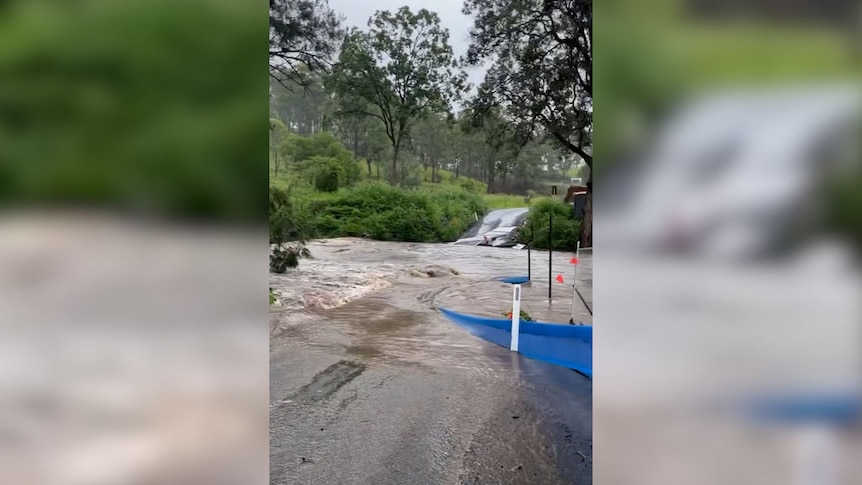 Car drives through floodwater