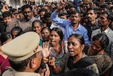 Demonstrators argue with a police officer in India.