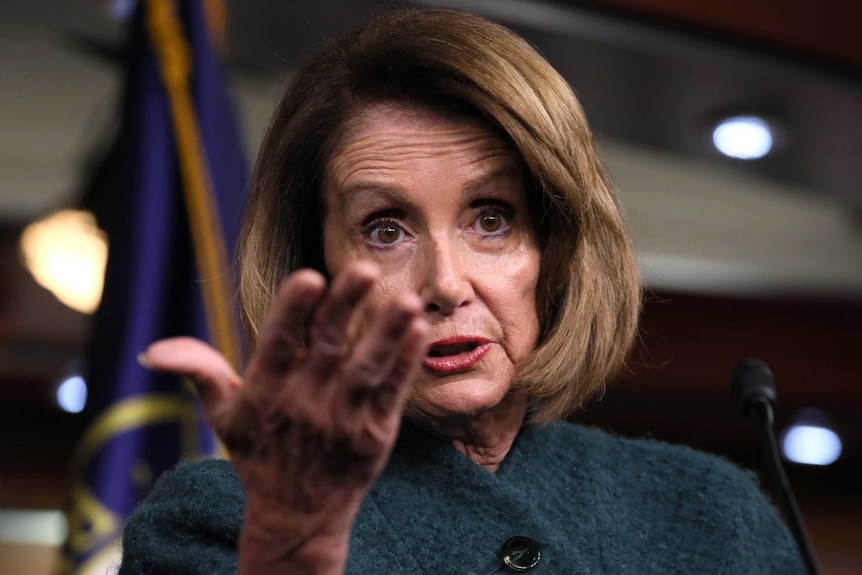 US House Speaker Nancy Pelosi gestures while speaking to reporters