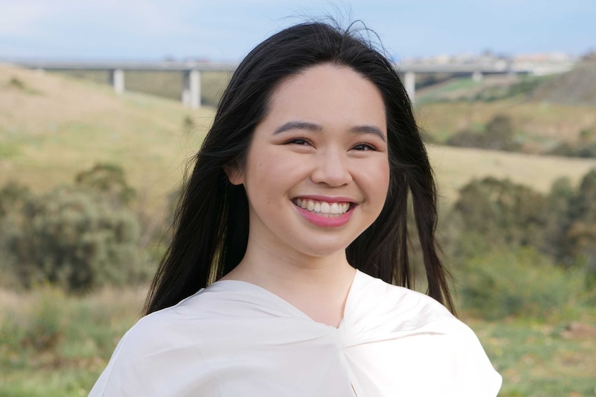 A young woman of Vietnamese heritage smiling