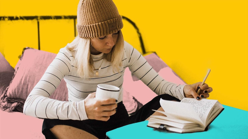 Young woman sitting on a bed holding a mug and writing in a journal to depict making time for personal projects.