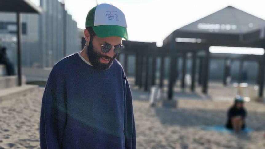 Adiel Cohney walks along a beach in Israel.